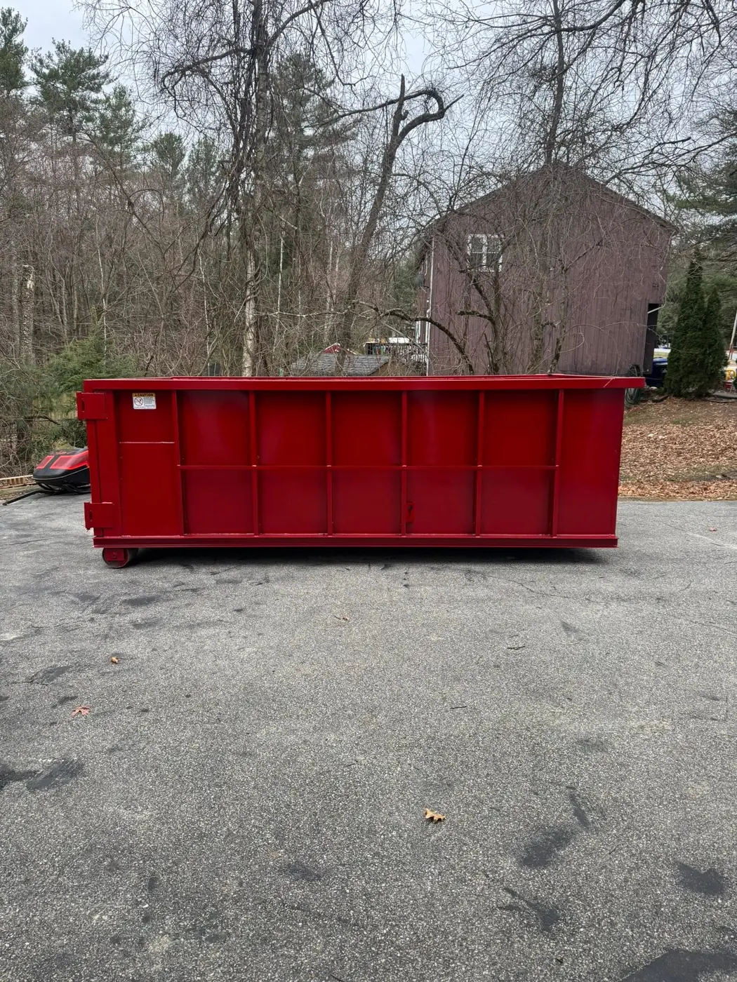 10 yard roll off dumpster rental parked on a driveway in southern New Hampshire